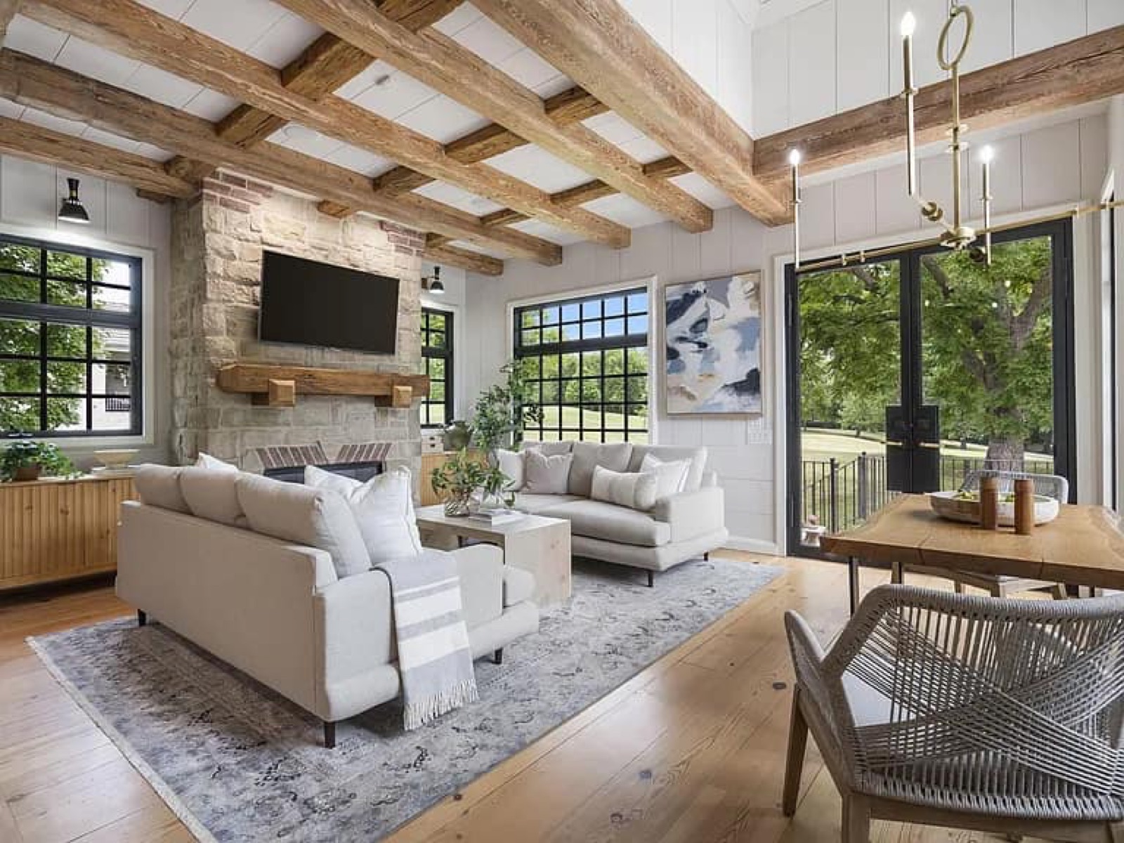 Family room with exposed beams and stone fireplace
